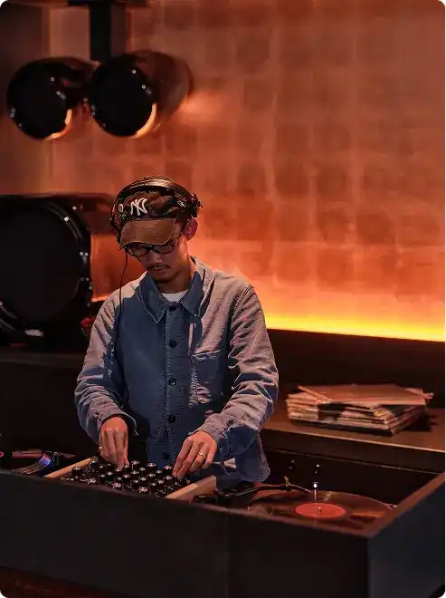 DJ spins vinyl in ambient lounge.