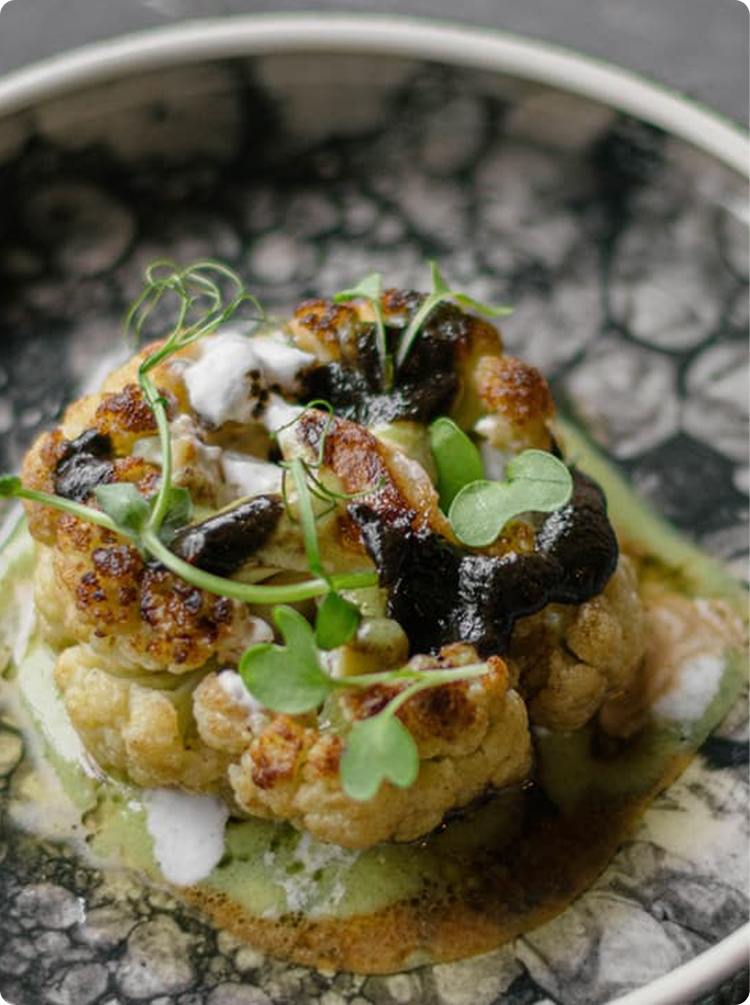 Roasted cauliflower steak with elegant plating.