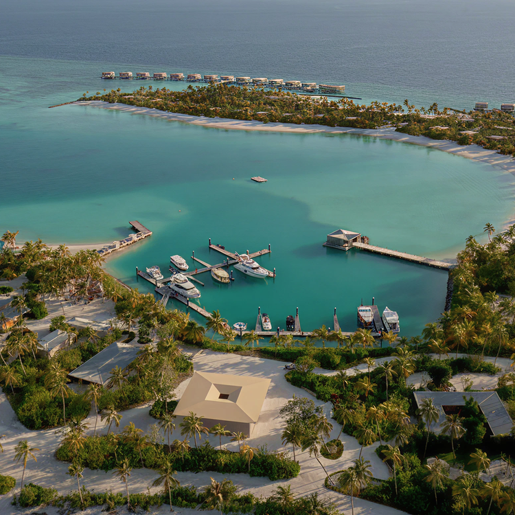 Boats docked near overwater bungalows